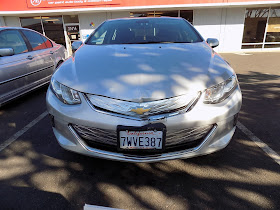 Damaged hood & bumper on 2017 Chevy Volt before collision repairs at Almost Everything Auto Body.