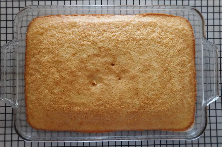 baked hot milk cake cooling in pan