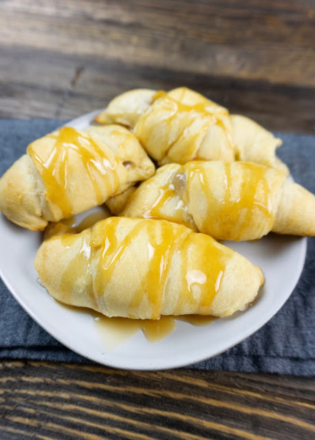croissants on a white plate with dark background.