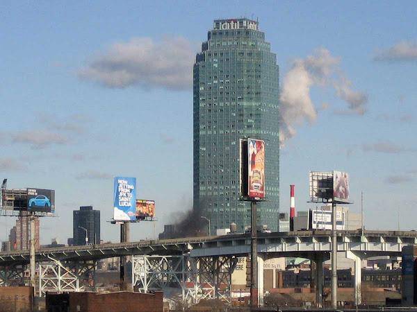 Citicorp Queens - White power plant exhaust and clouds behind, black smoke and the LIE below; from the Greenpoint Ave. bridge.