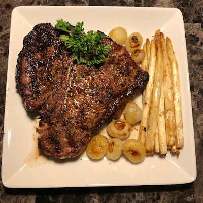 Rare porterhouse with bacon roasted asparagus and cipollini onions