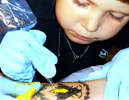 into his arm at the Adrenaline tattoo parlour, in Montreal, Canada.