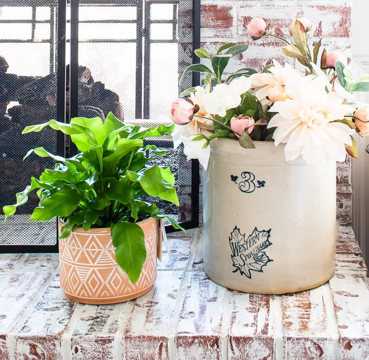 birds nest fern and antique crock filled with Spring florals