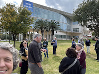 Our group outside a building; sign reads "We will grow from this together"