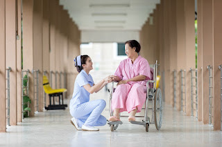 nurse and elderly woman in wheelchair