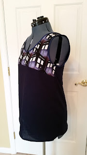 Side view of sleeveless shirt with Tardis on top and dark blue on the bottom.