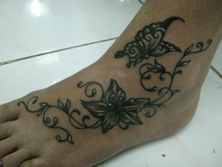 Butterfly and flowers tattoo on foot