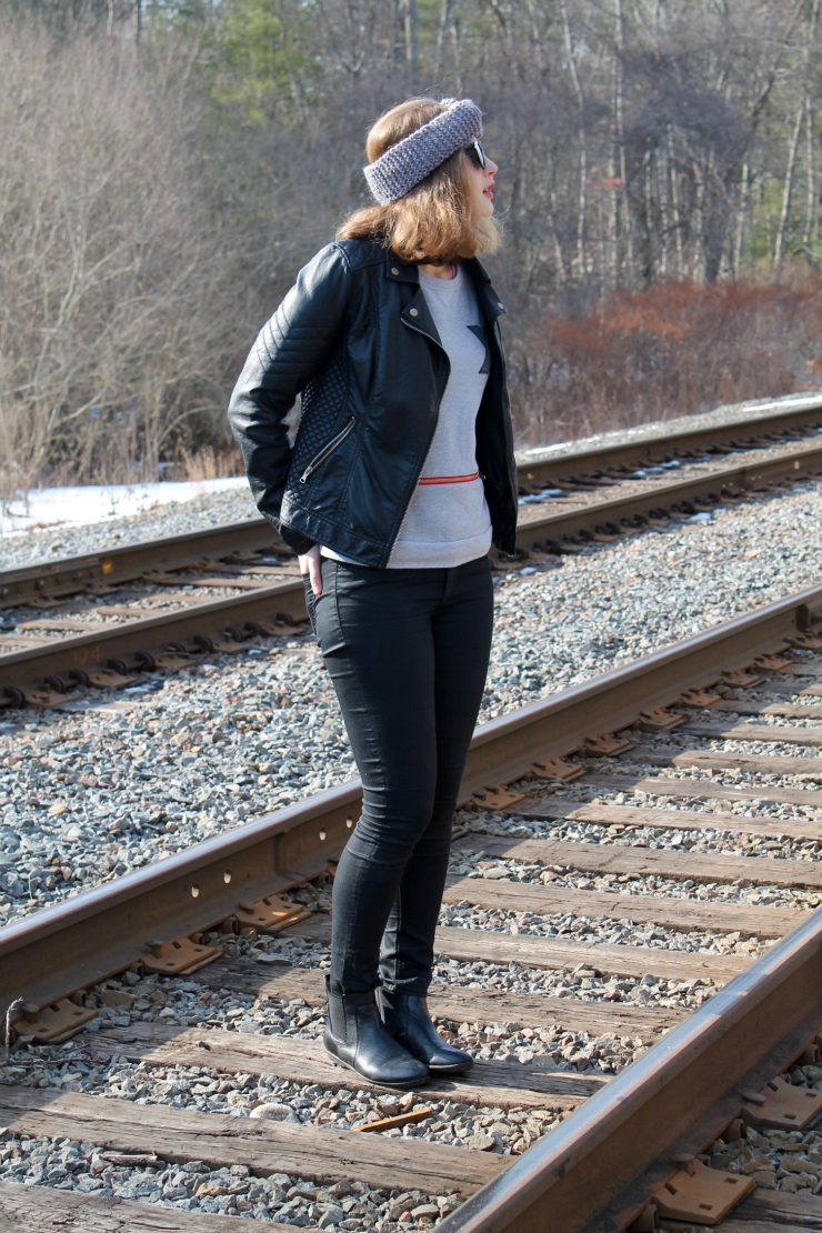 Funky sweatshirt, leather jacket, black skinny jeans and twisted ear warmer look for Winter outfit