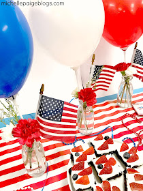 Patriotic brownies with red strawberries and blueberries.