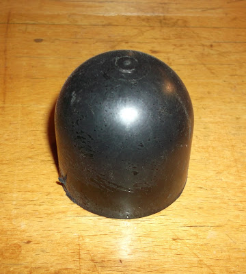 The plastic cover from an Opel Manta A series rear shock absorber top mount