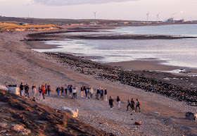 Photo of young people gathering on the beach later on the day their school closed (their faces have been blurred intentionally)