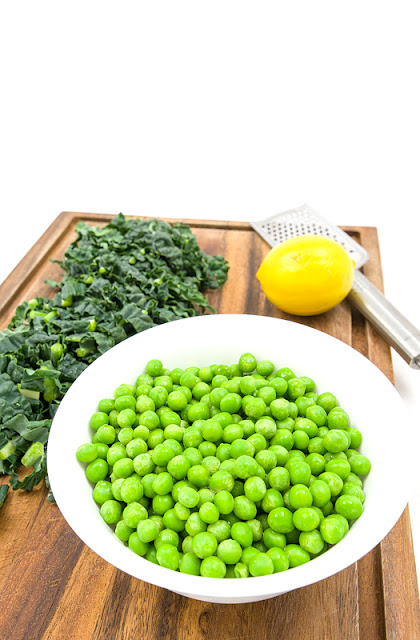 Kale and peas on cutting board