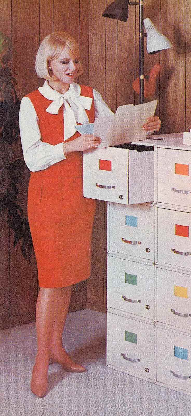 a very 1966 office photograph in color, woman in an orange dress with wood panelling