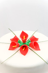 Red calla lily wedding cake fondant chocolate and peach cake close up on top of the cake