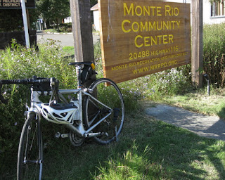 pep's bike and helmet parked next to the sign for the Monte Rio Community Center, Monte Rio, California