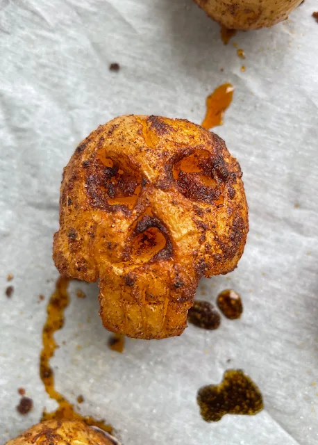 Close-up of a spooky roasted potato skull.