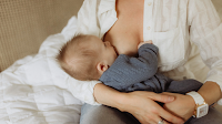 Profile of a mother breastfeeding her baby