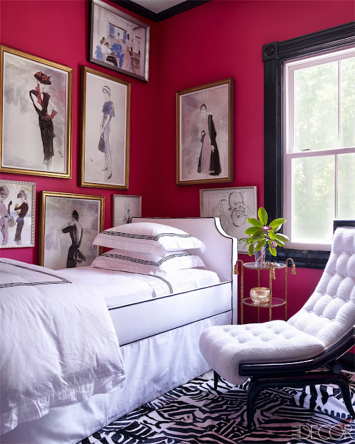 Pink guest bedroom in Oscar PR Girl's weekend home with vintage fashion sketches and a custom printed hide rug