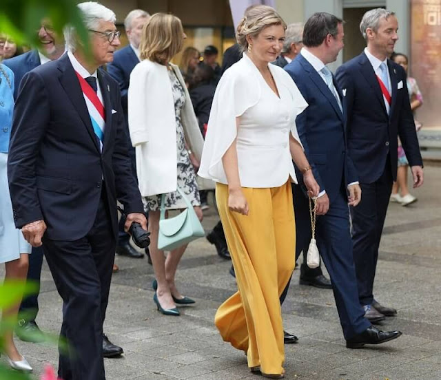 Princess Stephanie wore a white cape blouse, and yellow wide-leg trousers. Hereditary Grand Duchess Stephanie