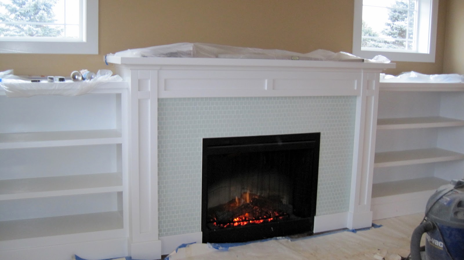 Built in shelves around fireplace Next to the white trim.