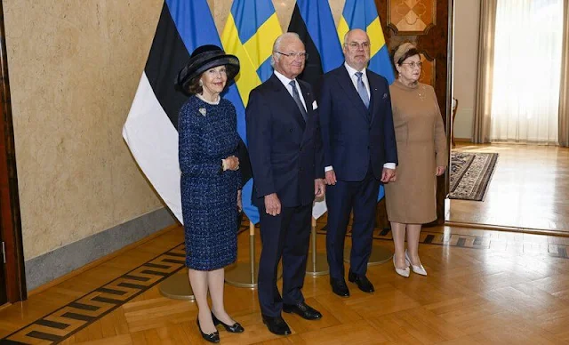 Queen Silvia wore a navy tweed coat, tweed jacket and navy tweed dress by Chanel. Mrs Sirje Karis and Prime Minister Kaja Kallas