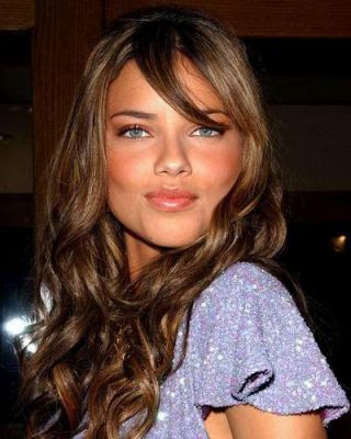 Adriana Lima long wavy hairstyle with partial bangs