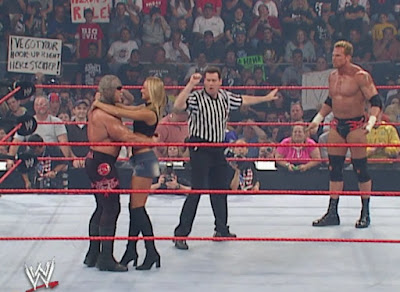WWE Unforgiven 2003 - Test looks irate as Stacy Keibler embraces Scott Steiner