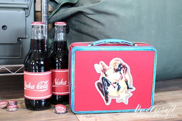 Again, scatter them on the floor and also use some stickers to top new bottles of soda as well. Can you tell how I made my Nuka Girl lunchbox?  **Secret is, it's a Superman lunchbox. I just covered the front and edges with red paper and then stuck my Nuka Girl Magnet, that I made for my hubby for Christmas, on the front. You could make this easily from a small cardboard box too!  All the details on this Nuka Girl magnet and other Fallout 4 themed magnets are on this post here.