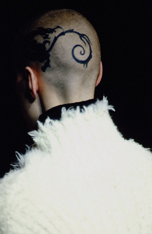 Nice black tribal dragon tattoo on a man's head