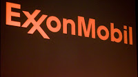 The logo of Exxon Mobil Corporation is shown on a monitor above the floor of the New York Stock Exchange in New York, New York, U.S. December 30, 2015.  (Credit: Reuters/Lucas Jackson/File Photo) Click to Enlarge.