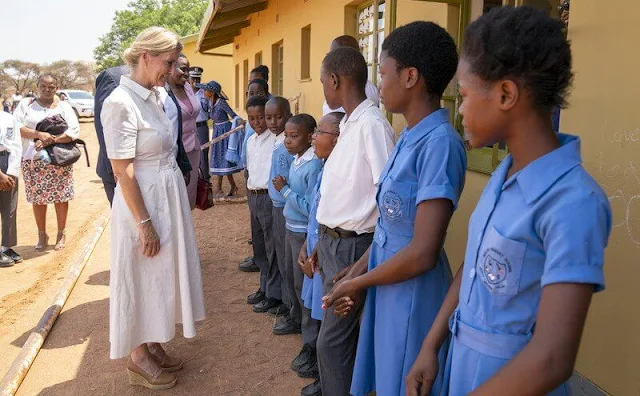 The Countess of Wessex wore a pique linen cotton belted white shirtdress by Co, and classic silk tea dress by Suzannah