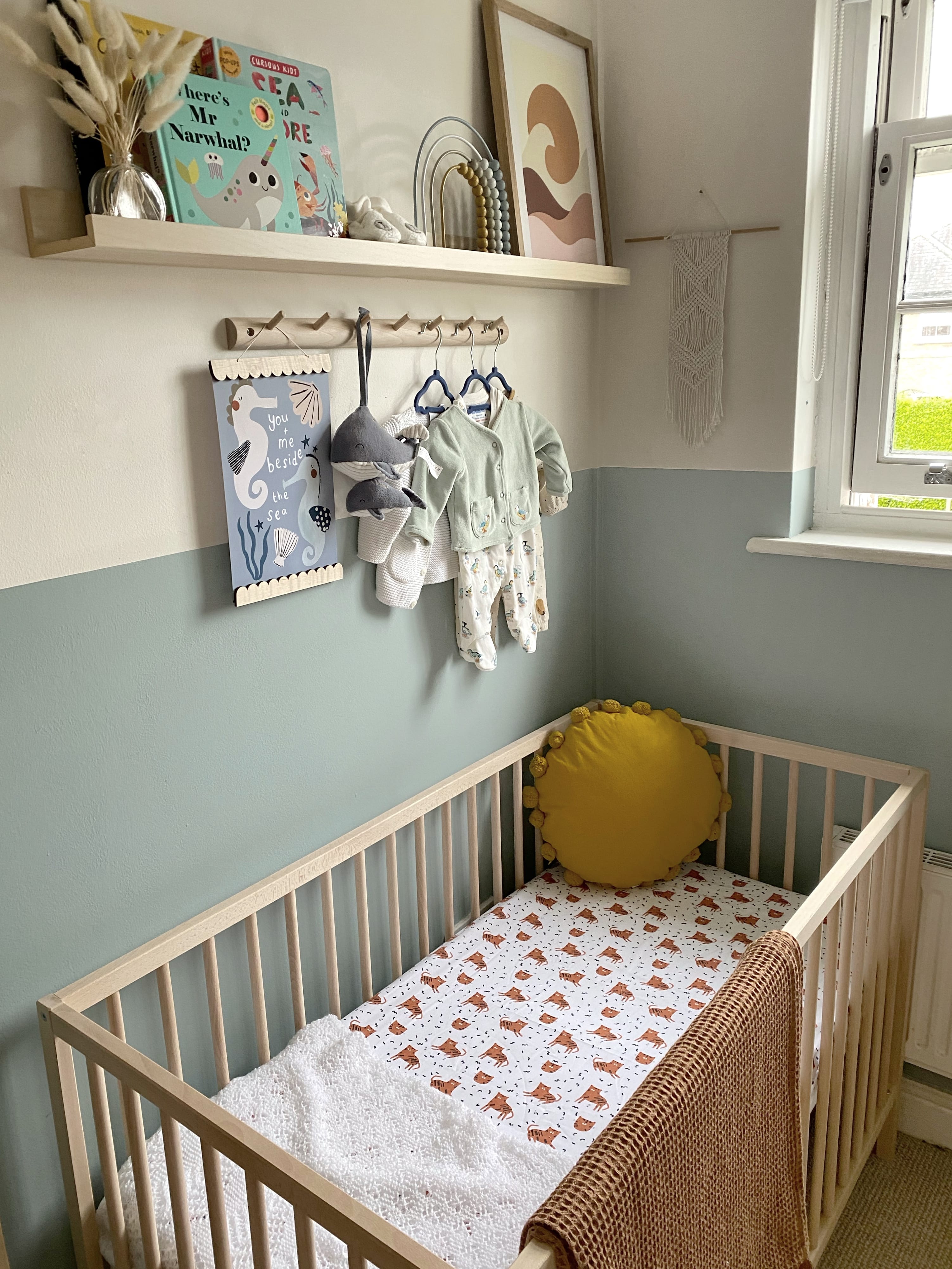 Under the sea ocean themed baby nursery inspiration budget. Gender neutral child's bedroom in blue and mustard yellow with half-painted colour block