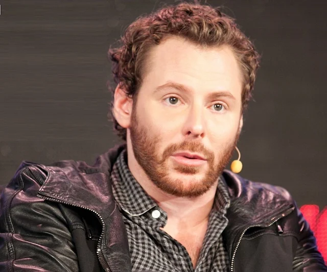 On Parker wearing a fashionable dark leather jacket from shoulder support