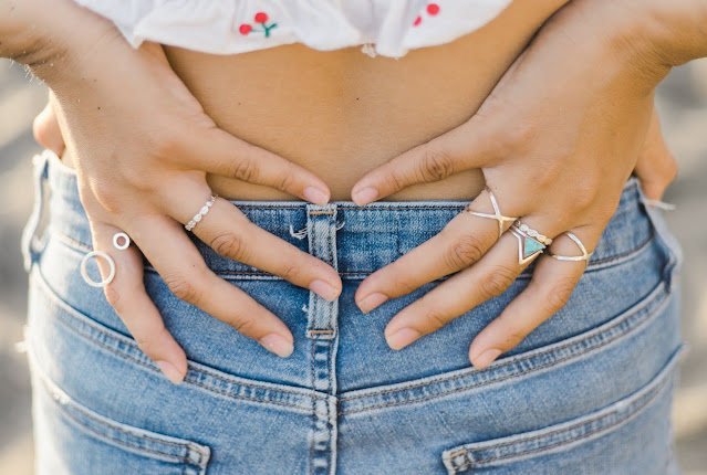 Close up of a pair of hands with rings.