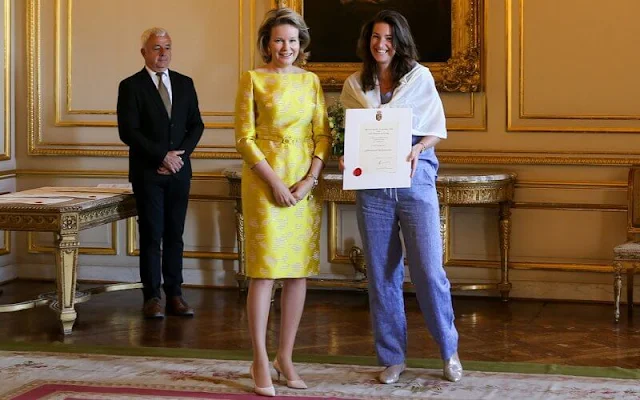 Queen Mathilde wore a yellow embroidered silk satin midi dress by Belgian designer Edouard Vermeulen