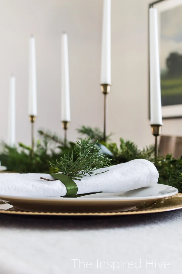 Fresh greenery holiday tablescape in a modern traditional dining room