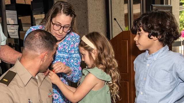 A family gathers around a graduating student