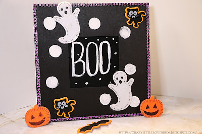 Black picture frame with Halloween decorations displayed