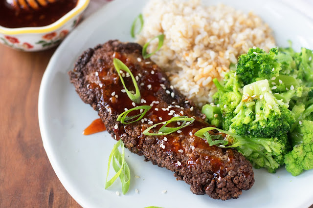 The finished Sweet and Spicy Asian Fried Chicken on a plate with steamed broccoli and rice. 