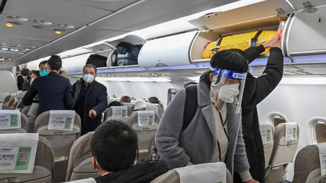 WHO urges travellers to wear masks as new COVID variant spreads