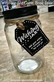 Mason jar with black tag sitting on the floor.