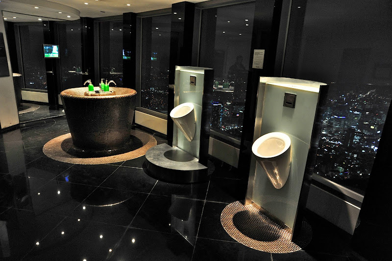 Beatifully designed urinals in the men's restroom overlook the city of  title=