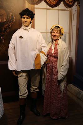 Rachel in Regency costume posing with Mr Darcy  at the Jane Austen Centre in Bath