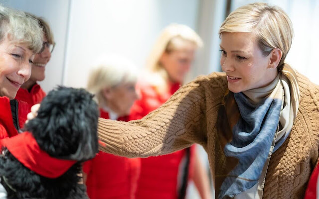 Princess Charlene wore a new Emory brown cable-knit wool blend sweater by Emilia Wickstead. Chien de Coeur foundation