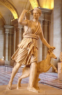 Goddess Artemis with her bow and  arrows, and accompanied by a deer. 