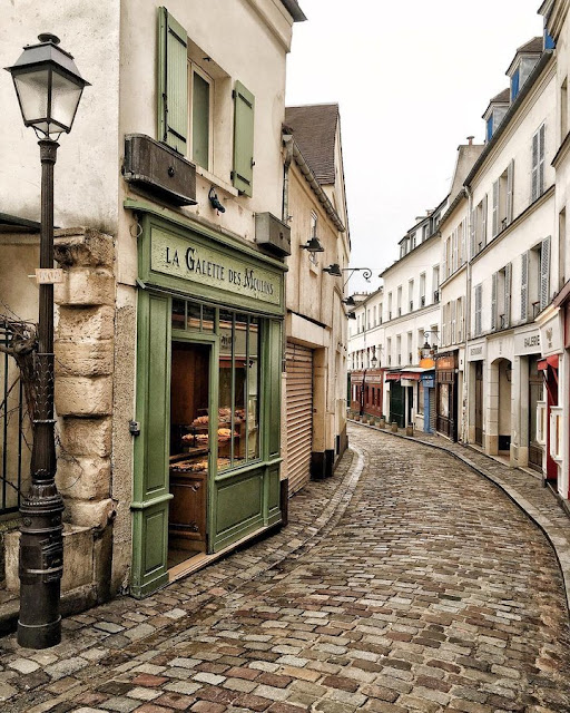 the winding cobble street, Rue Norvins in Montmartre