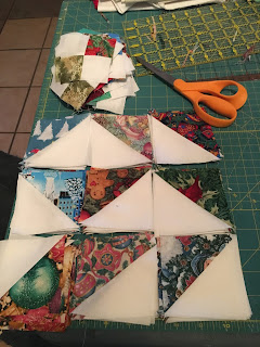 Assembled half-square triangles and 4-square blocks, to be made into squares.