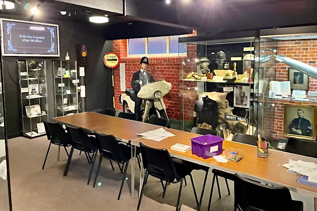 Display cabinets and a long table and chairs at the Police Museum