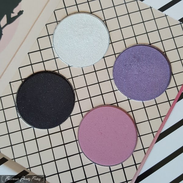 open palette with 3 eyeshadow pans and pink powder blush on fishnet print background