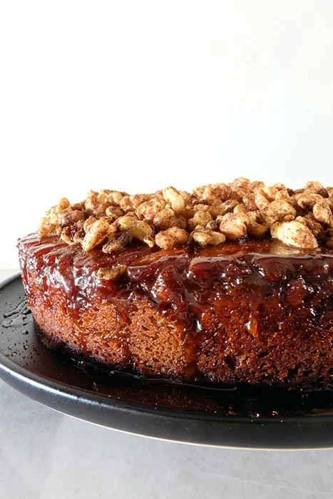 close up of brown sugar apple upside down cake with cider caramel and spiced walnuts